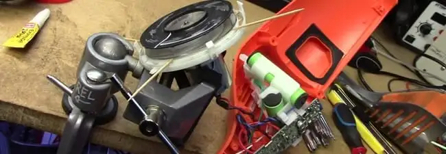 Vacuum cleaner repair parts and tools on a workbench in Tulsa, OK