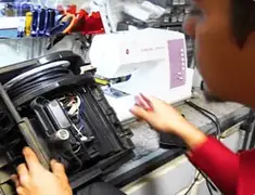 Vacuum repair technician servicing internal components on a workbench in Tulsa, OK