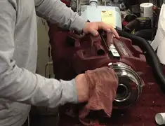 Vacuum repair technician cleaning and servicing a vacuum motor in Tulsa, OK